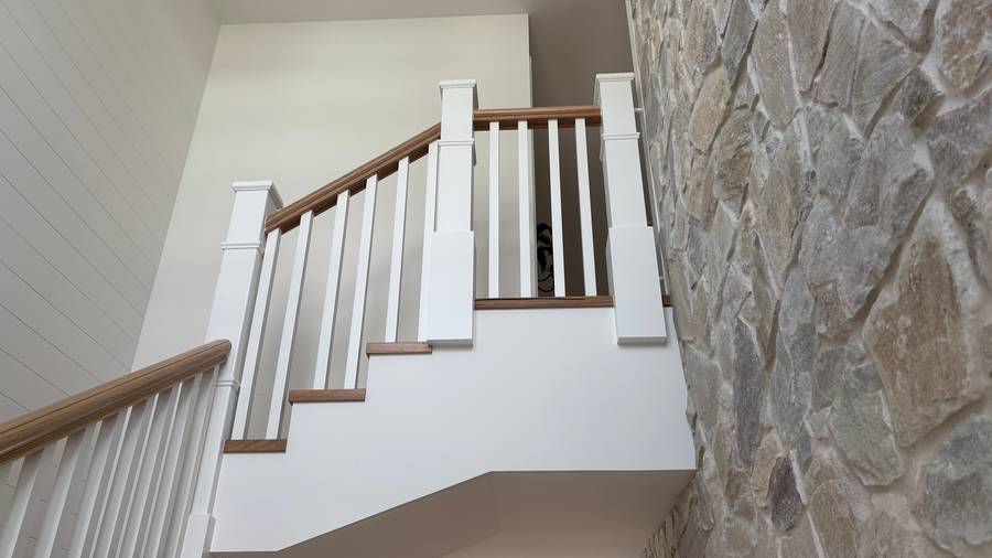 Interior staircase with stone feature wall